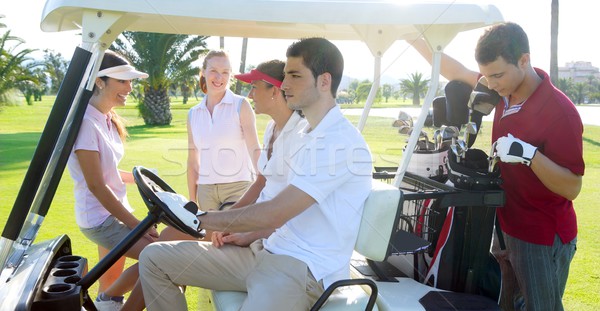 Golf course young people group buggy green field Stock photo © lunamarina