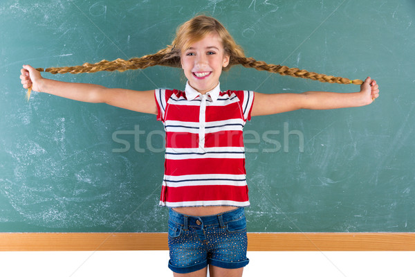 Diák szőke lány játszik fonatok zöld Stock fotó © lunamarina