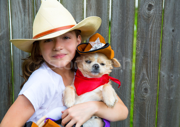 Beautiful cowboy kid girl holding chihuahua with sheriff hat Stock photo © lunamarina