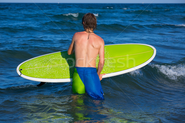 boy surfer waiting for the waves on the beach Stock photo © lunamarina