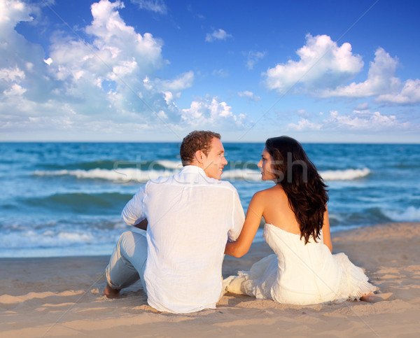 Stock photo: couple in love sitting in blue beach