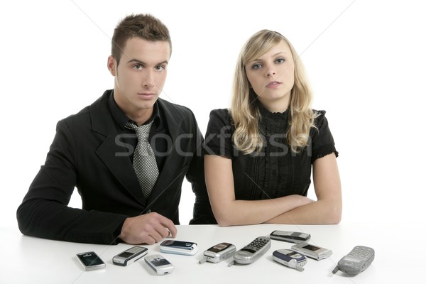 Business couple with many mobile telephones Stock photo © lunamarina