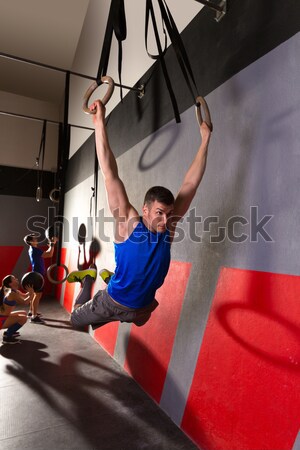 Muscle ups rings woman swing workout at gym Stock photo © lunamarina