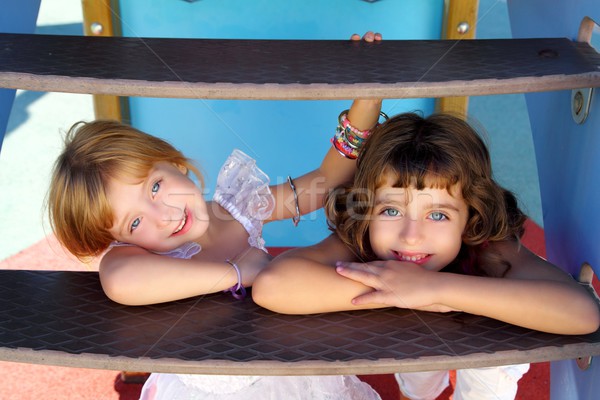 blue eyes little sister girls similing in playground stairs Stock photo © lunamarina