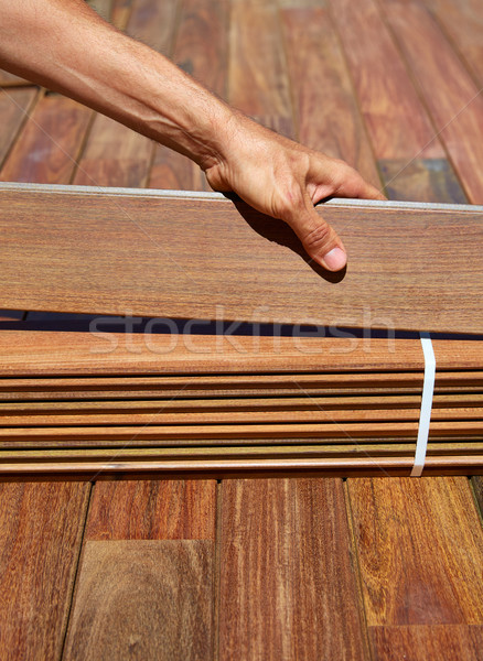 Ipe deck installation carpenter hands holding wood Stock photo © lunamarina