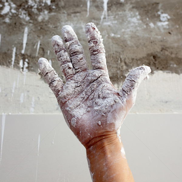 Stock photo: Astist plastering man hand with cracked plaster