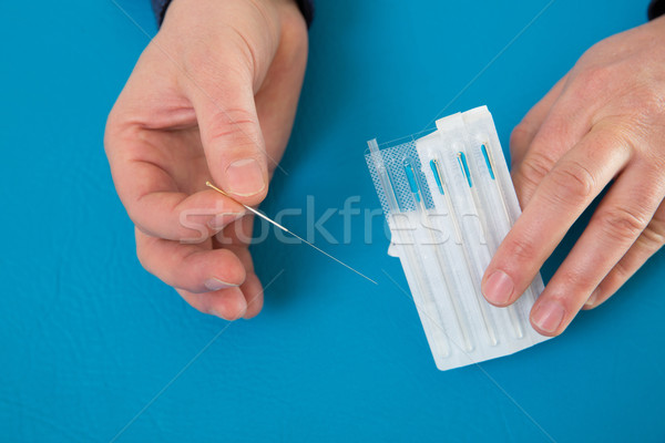Acupuncture needles in doctor hands holding blister Stock photo © lunamarina