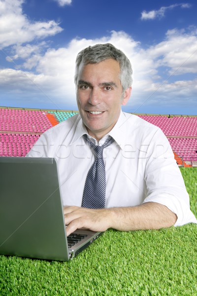 senior businessman working on grass in sport course Stock photo © lunamarina