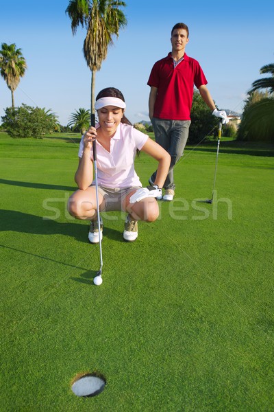 young golf woman looking and aiming the hole Stock photo © lunamarina
