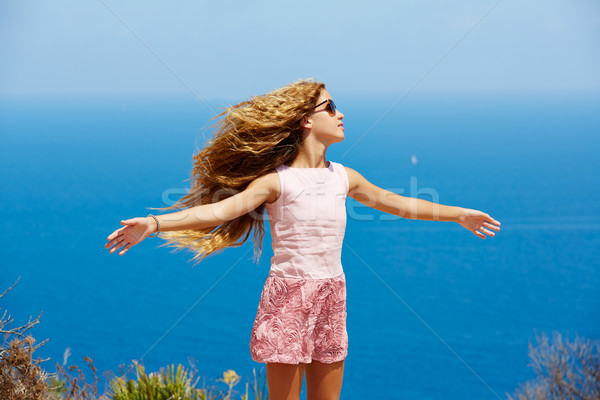 Blond girl shaking hair on air at blue Mediterranean Stock photo © lunamarina