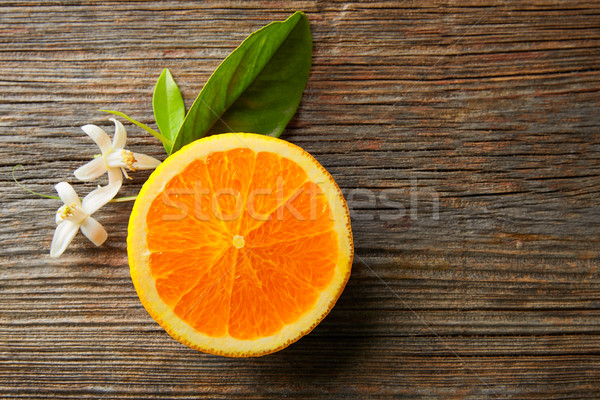 Cut open orange fruit with orange flower Stock photo © lunamarina