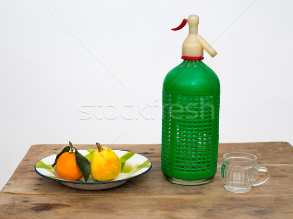 fruits tangerine and pear in vintage dish soda bottle Stock photo © lunamarina