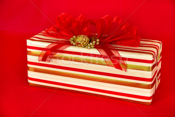 Red, Gold and White Striped Gift Package with Red Ribbons Stock photo © LynneAlbright