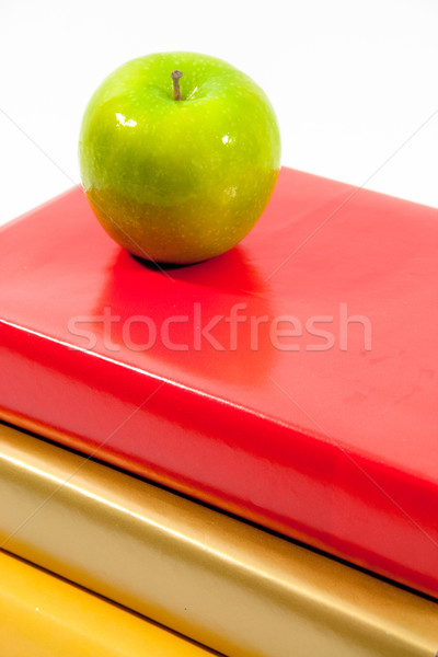Green Apple and  Red, Gold and Yellow Books Stock photo © LynneAlbright