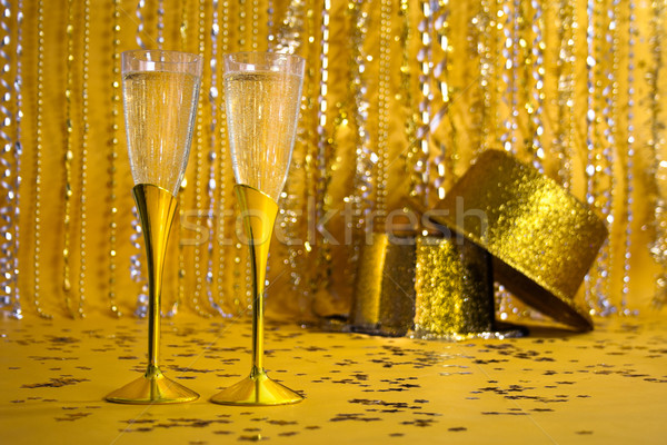 Two Gold Champagne Flutes with Gold Sequined Party Hats Stock photo © LynneAlbright