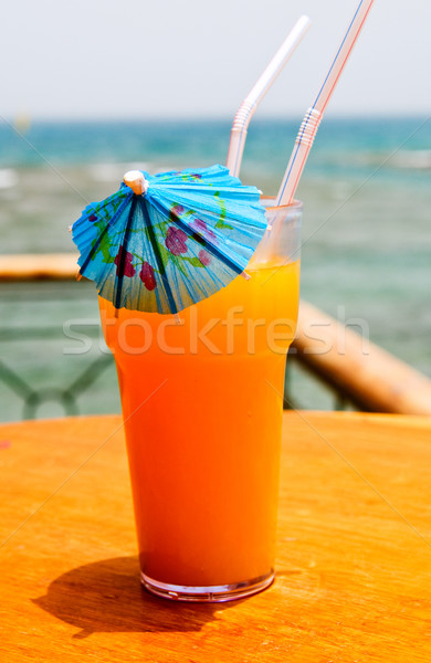 Tasty cocktail with paper umbrella against Red Sea. Stock photo © lypnyk2