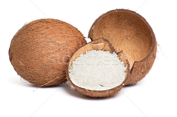 Stock photo: Whole and broken coconut on a white.