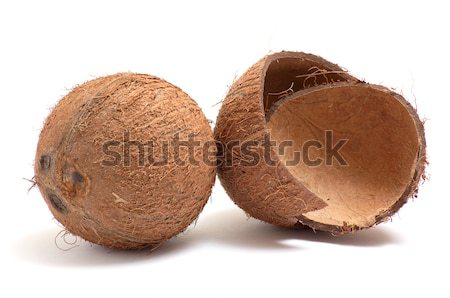 Stock photo: Whole and broken coconuts on a white.