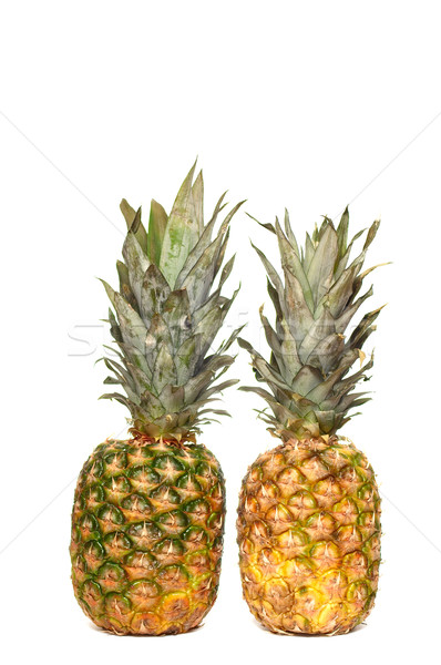 Fresh ripe  pineapples on a white background. Stock photo © lypnyk2
