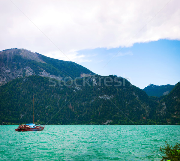 Yacht on a blue alpine lake. Stock photo © macsim