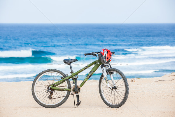 Bicycle with helmet, stand on the beach. Stock photo © macsim