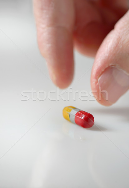 hand picking up a pill Stock photo © mady70