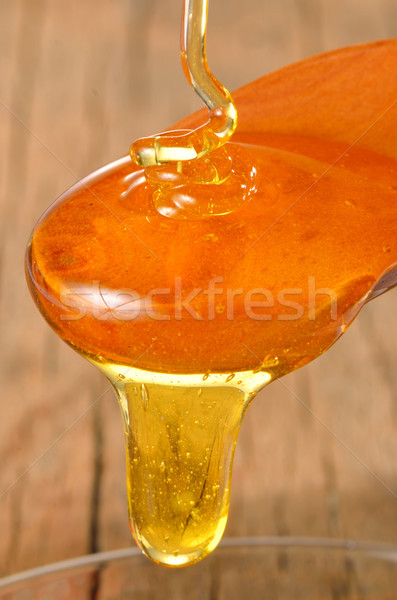 honey flowing in a glass bowl Stock photo © mady70