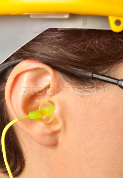 yellow earplug into the ear Stock photo © mady70