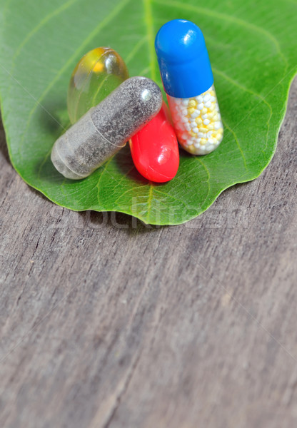 vitamins, tablets and pills on green leaf Stock photo © mady70