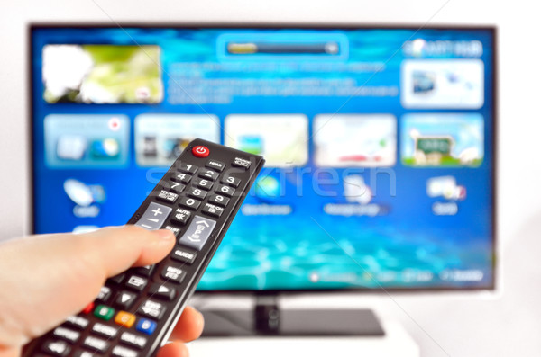 Smart tv and  hand pressing remote control Stock photo © mady70