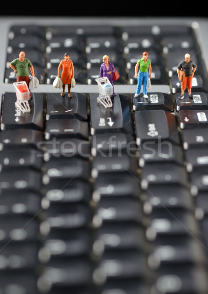 Miniature shoppers with shopping cart  Stock photo © mady70