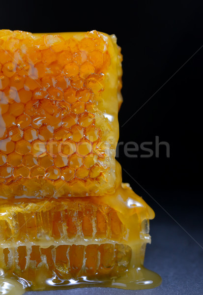Honeycomb on black ardesia plate Stock photo © mady70