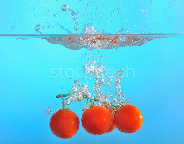 red tomatoes dropped into water Stock photo © mady70