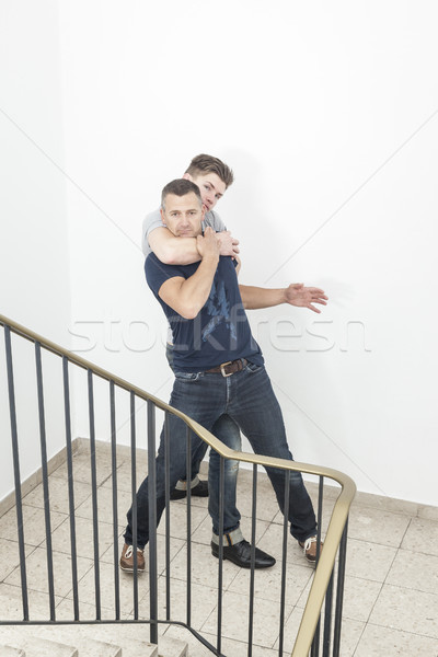 a two men fight at the staircase Stock photo © magann