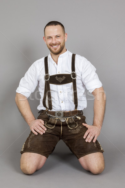 man in bavarian traditional lederhosen kneeling Stock photo © magann