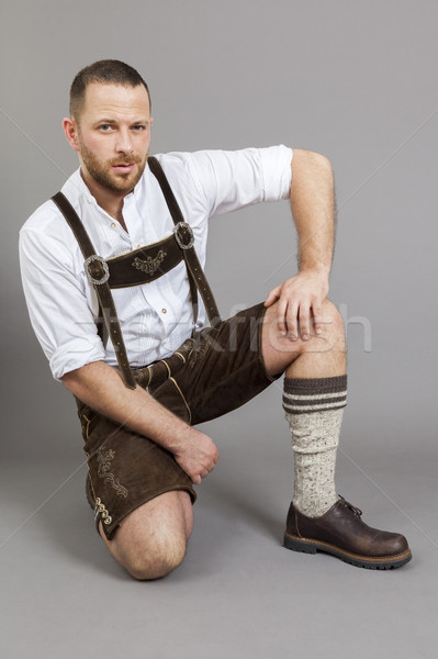 man in bavarian traditional lederhosen kneeling Stock photo © magann