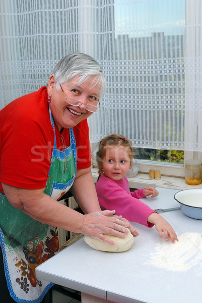 Grandmother and granddaughter knead the dough Stock photo © mahout