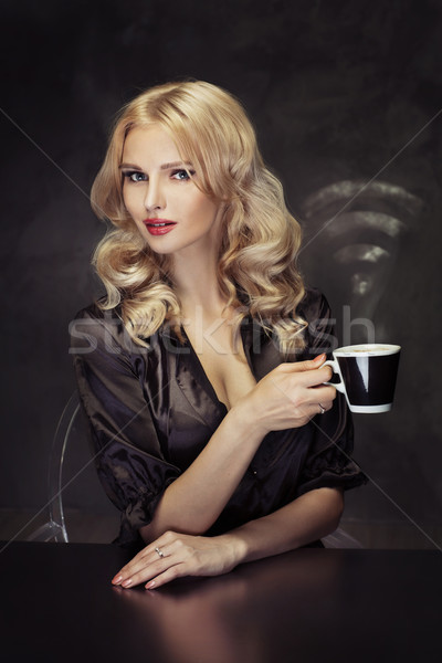 Beautiful woman holding the vaporous cup of coffee Stock photo © majdansky