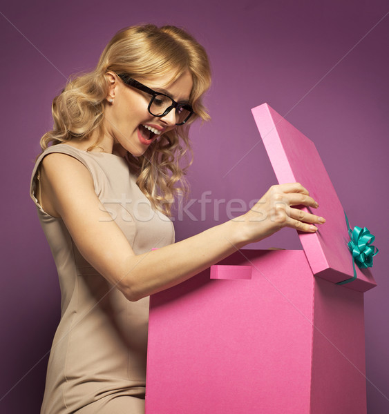 Charming blond lady opening a gift box Stock photo © majdansky