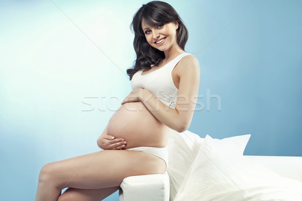 Beautiful pregnant lady stroking her stomach Stock photo © majdansky