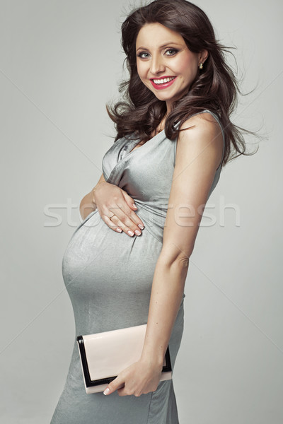 Beautiful pregnant woman presenting her belly Stock photo © majdansky
