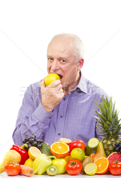 senior man eating a green apple Stock photo © manaemedia