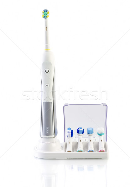 White Electric Toothbrush with stand charger on white Stock photo © manaemedia