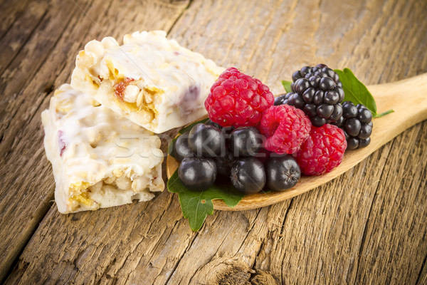 muesli bars with fresh berries in spoon on wooden Stock photo © manaemedia