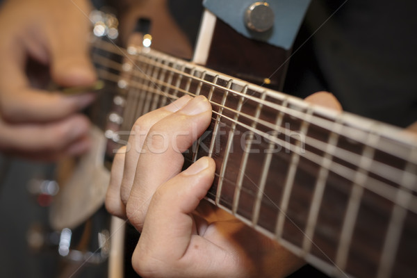 close up shot of a man with his fingers on the frets of a guitar Stock photo © manaemedia