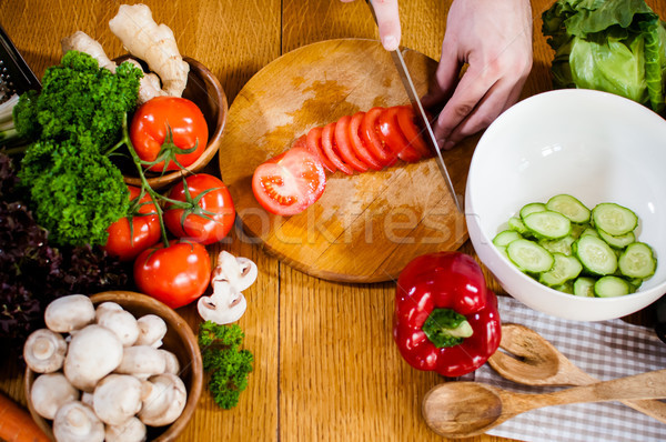 Man cuts fresh spring vegetables Stock photo © manera