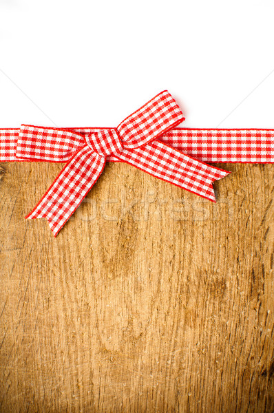 Stock photo: Wooden background with a red checkered ribbon