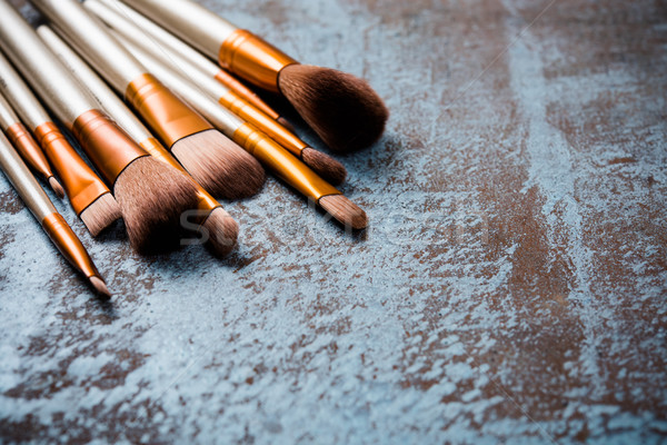 Stock photo: makeup brushes collection, new make-up tools set on painted back