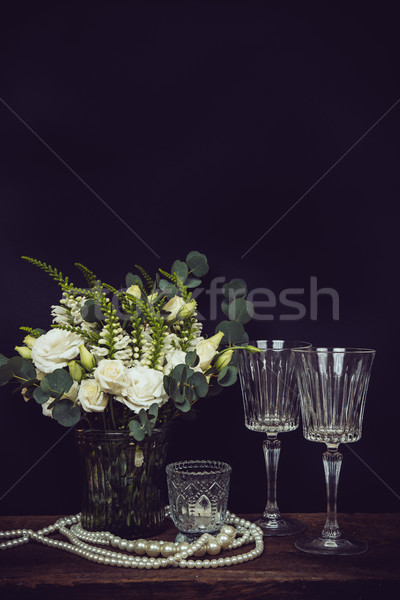bouquet of white flowers, pearl beads and wine glasses on a blac Stock photo © manera