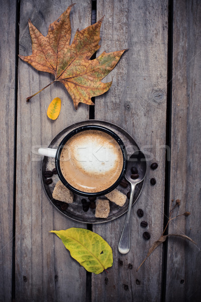 Cozy autumn, cup of coffee and yellow leaves Stock photo © manera